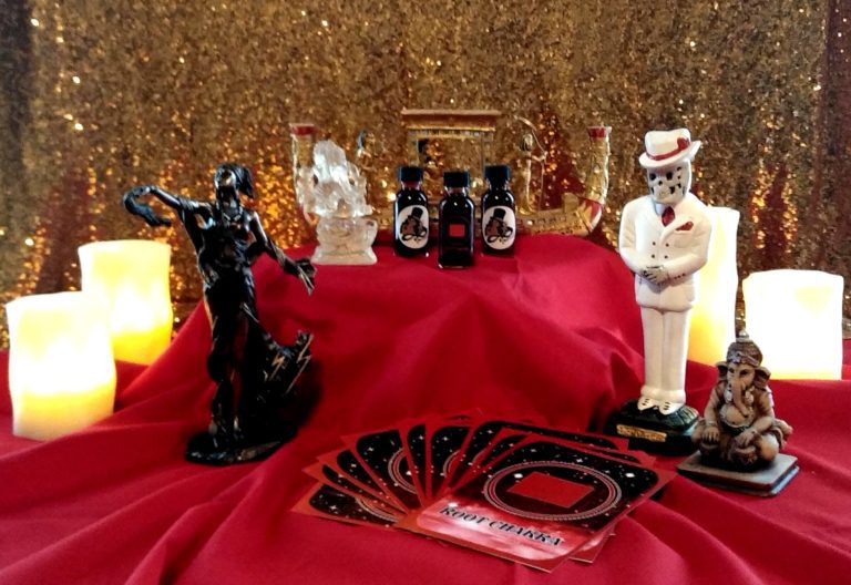 A table with red cloth and various figurines.