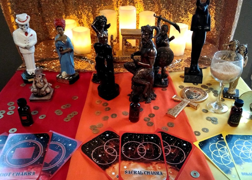 An altar with candles, statues, and other ritual items.