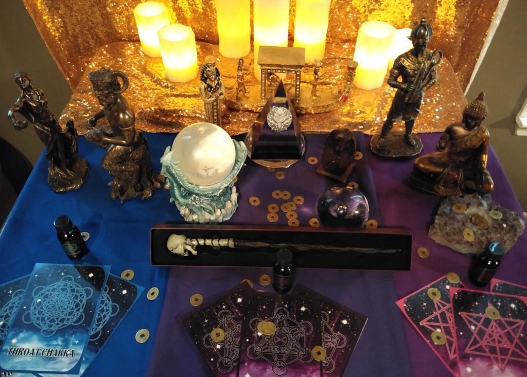 Altar with candles, crystals, and statues.