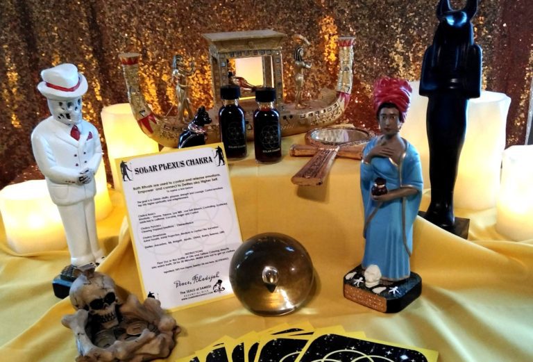 A table with several items on it including figurines and a crystal ball.