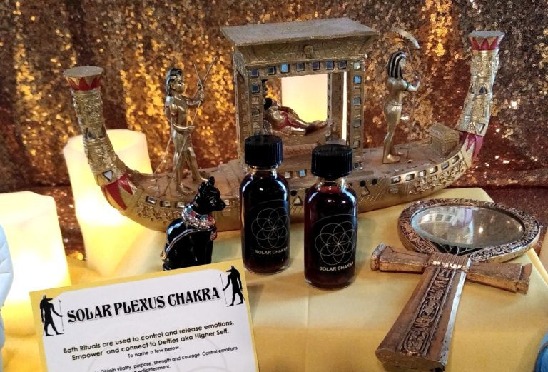 A table with two bottles of perfume and other items.
